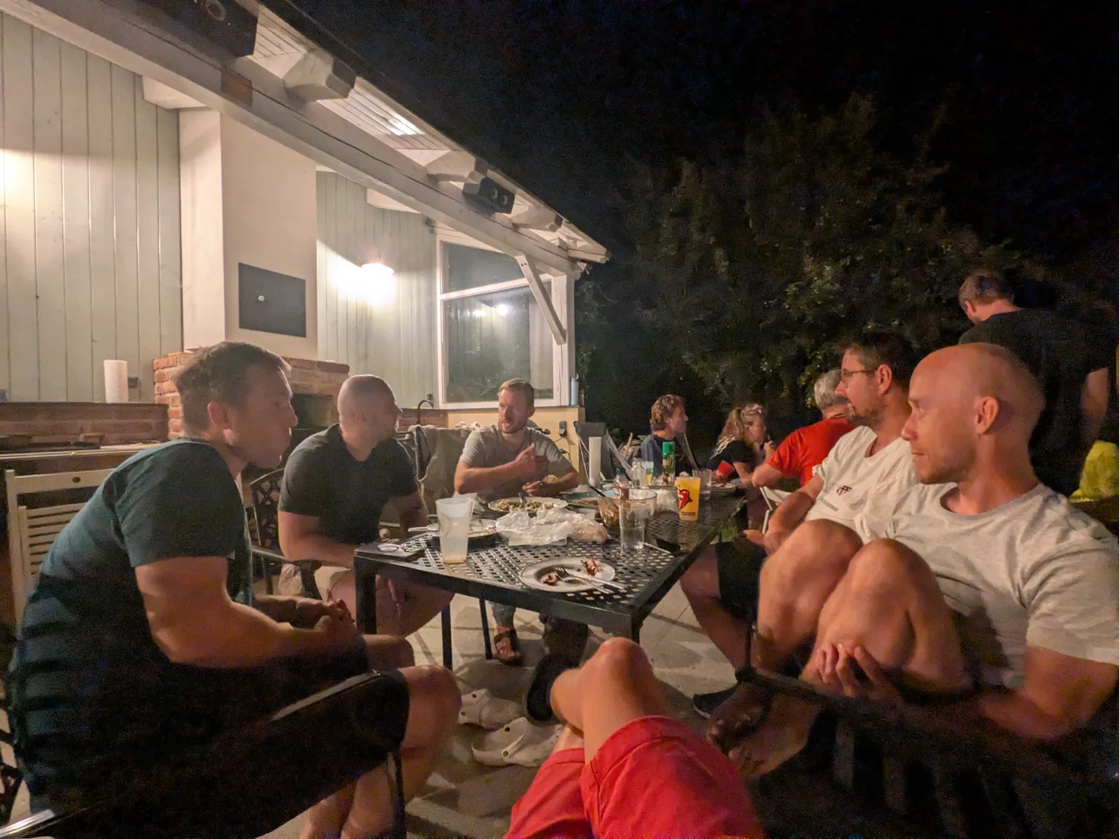 The crew at an evening table on the mill terrace